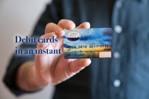 debit cards in an instant - photo of a man holding debit card